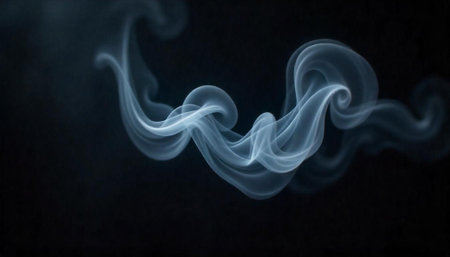Wispy blue smoke trails rising against a dark backdropの写真素材