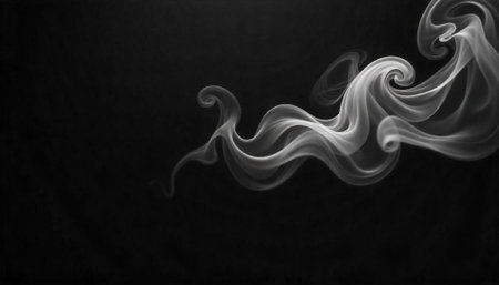 Elegant flowing white smoke on dark abstract backgroundの写真素材