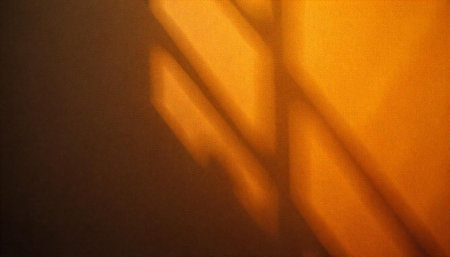 Abstract orange background with window light and shadow patternsの写真素材