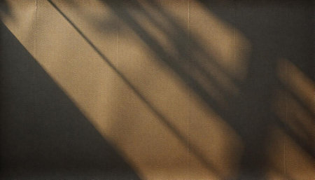 Textured wall with diagonal sunlight shadows create abstract patternの写真素材