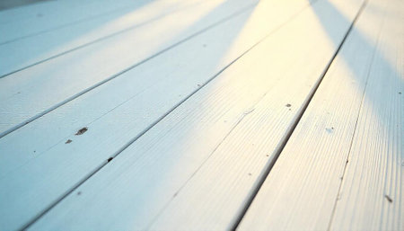 White wooden planks angled with soft light and shadowsの写真素材