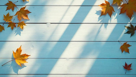 Autumn maple leaves on a white wooden background