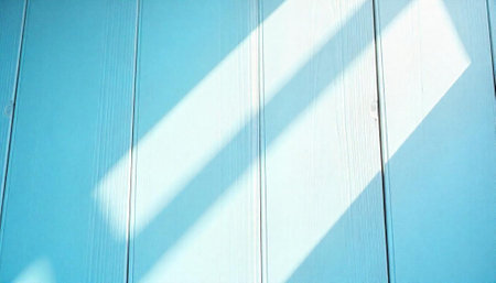 Turquoise wooden planks with diagonal sunlight, simple background imageの写真素材