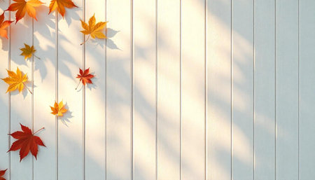 Autumn leaves casting shadows on a white wooden wall