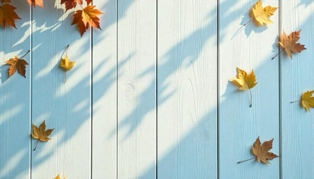 Autumn leaves on a light blue wooden plank surface