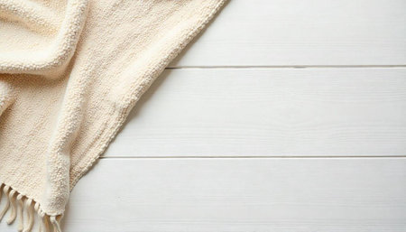 Cozy beige blanket on white wooden surface tabletopの写真素材