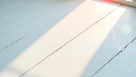 Sunlight on white wooden planks background stock image
