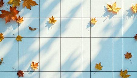 Autumn Leaves on White Tiled Surface with Light Shadowsの写真素材