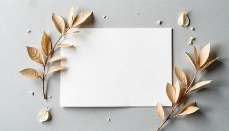 Elegant blank card with gold leaf accents on grayの写真素材