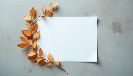 Blank paper with autumn leaves on a textured backgroundの写真素材