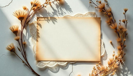 Blank paper and floral arrangement with lace doily overlayの写真素材