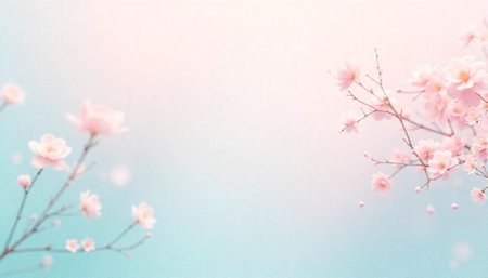 Soft pink cherry blossoms against a pastel blue gradientの写真素材