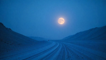 Full moon over winter road in arctic landscapeの写真素材