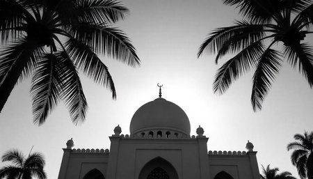 Black and white view of a mosque framed by palms