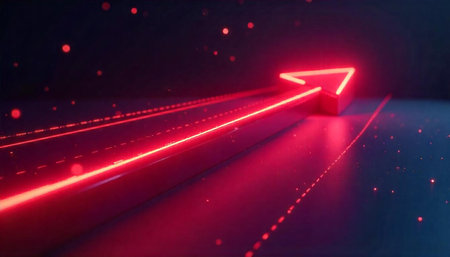 Neon red arrow pointing upwards on a dark surfaceの写真素材