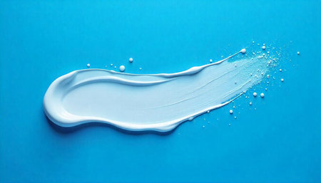 Cosmetic cream smear on blue background, beauty product concept