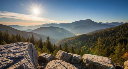 Sunrise over mountain range with rocks in foreground viewの写真素材