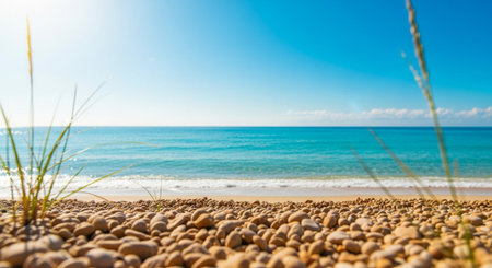 Pebble beach on sunny day with turquoise ocean viewの写真素材