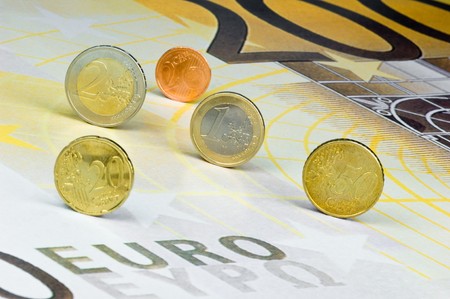 Euro-coins rolling over a 200-Euro-banknoteの写真素材