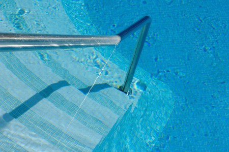 Stair and hanrail into a swimming poolの写真素材