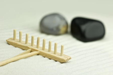 Miniature zen garden with two stones and wooden rakeの写真素材