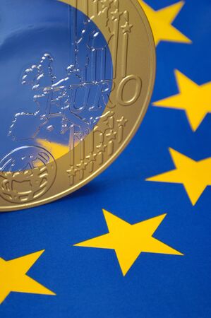 Euro coin on a european flagの写真素材