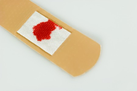Used adhesive plaster with a red bloodspotの写真素材