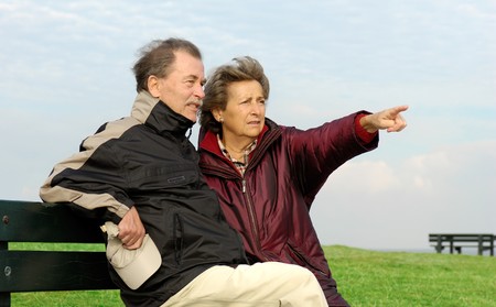 Senior couple on a park benchの写真素材
