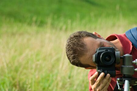 Photographer on a meadowの写真素材