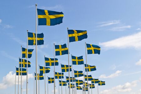 Swedish flag sway in the breeze against the skyの写真素材