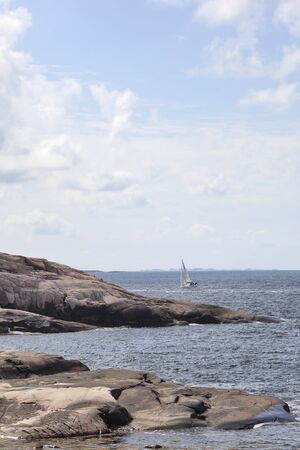 Rocky coast and sea View with sail boats at seaの写真素材