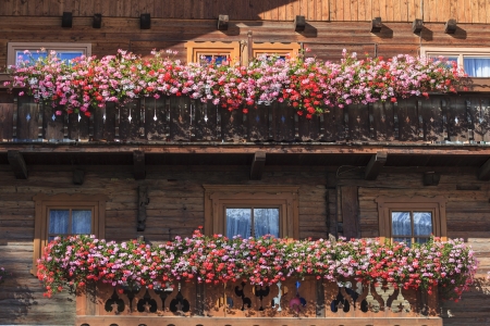 Alp house with a balcony with flower boxesの写真素材