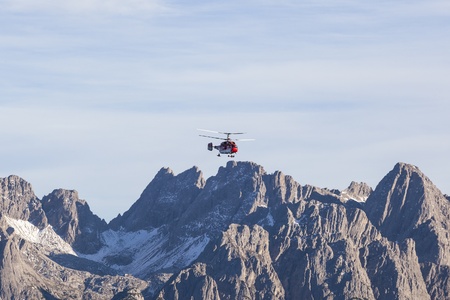 Helicopter flying over the mountainsの写真素材
