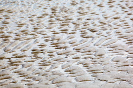 Wave patterns in the sand on the beach