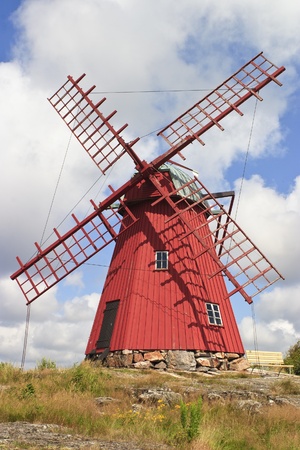Red windmill on a hillの写真素材
