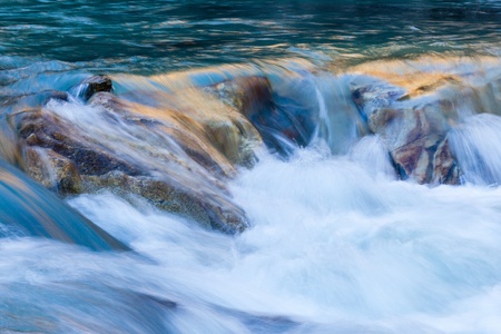 Flowing water in a rapid riverの写真素材