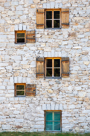 Old stone house with window shuttersのeditorial素材