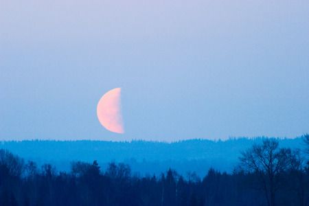 Big half moon over the landscapeの写真素材