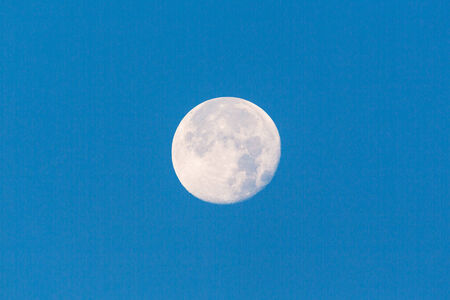 Full moon in the blue sky
