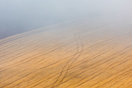 Misty morning over the stubble fieldの写真素材