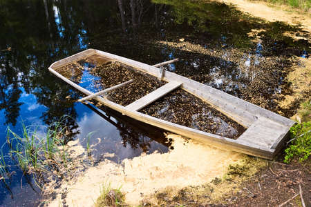 Rowing boat full of waterの写真素材