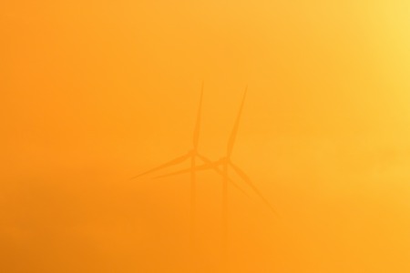Wind turbines in misty morningの写真素材