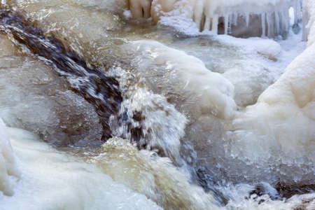 Water flowing in the iceの写真素材