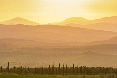 Sunset over the rolling landscapeの写真素材