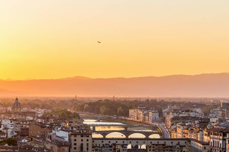 Sunset view of Florence in Italy with a airliner that liftsの写真素材
