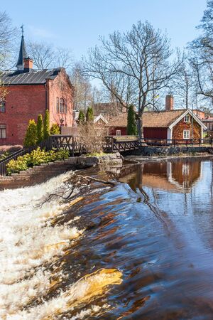Waterfalls and an old power plant on a river in Tidaholm, Swedenの写真素材