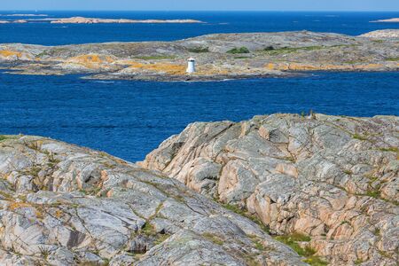 Lighthouse among the cliffs in the rocky sea archipelagoの写真素材