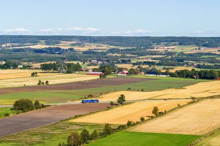 Landscape with field and road with trafficの写真素材