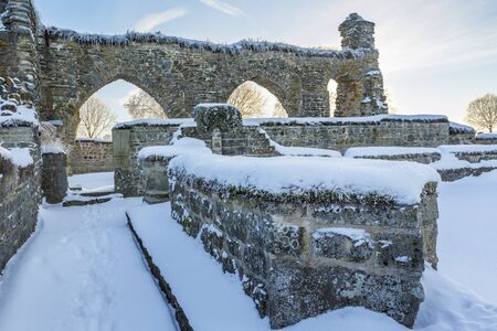Old monastery ruins with snowの写真素材