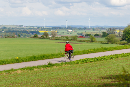 Woman cycling on a country roadの写真素材